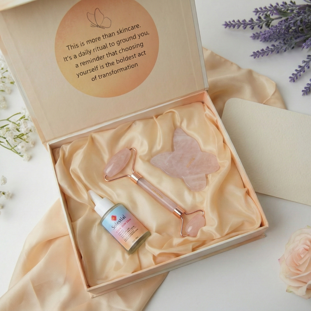 Solestial Glow Kit skincare set with rose quartz roller, vitamin c serum bottle, and butterfly gua sha tool in a decorative box on a light background.